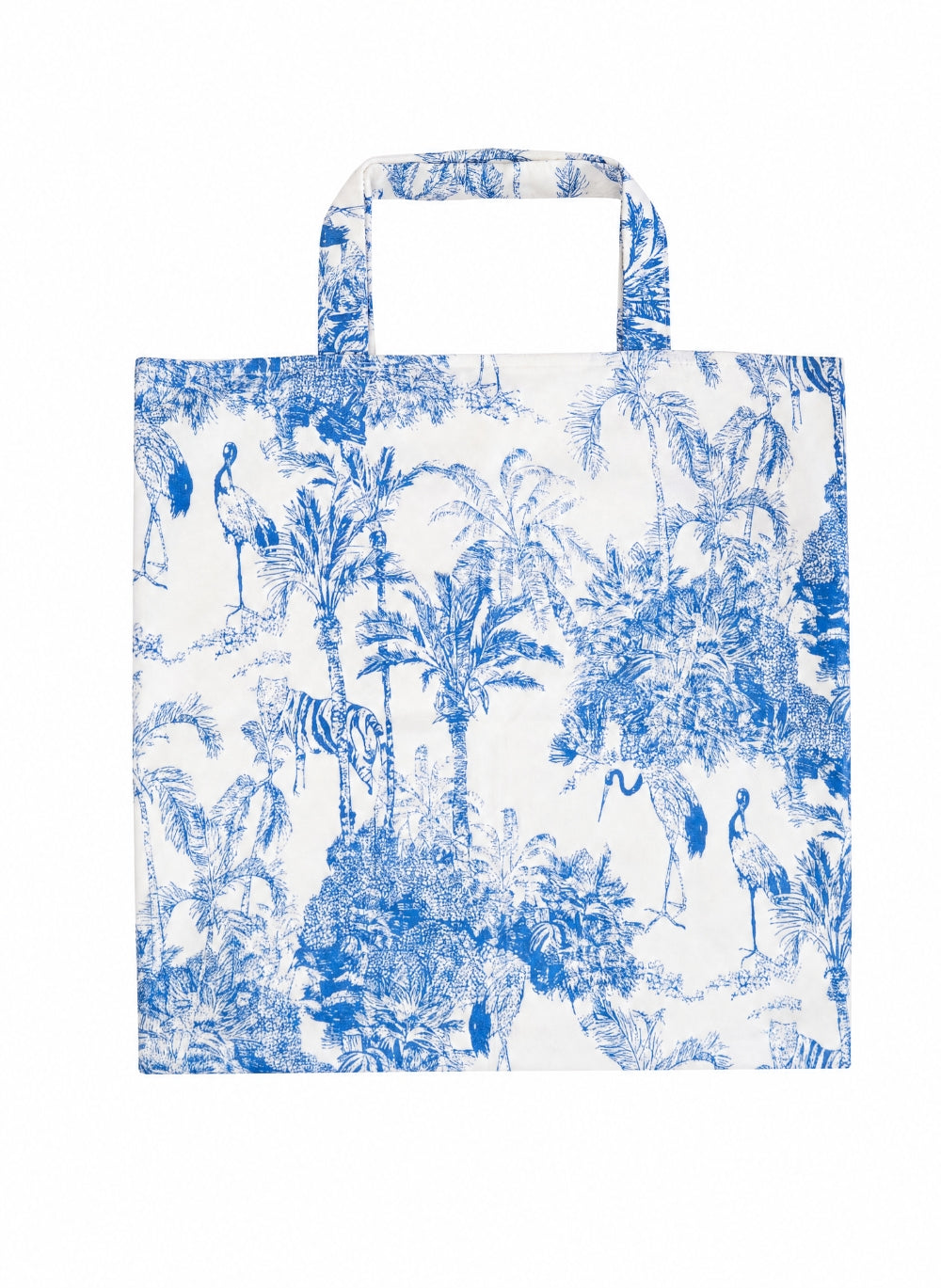 A white canvas tote bag featuring a blue toile de Jouy pattern with palm trees, flamingos, and zebras, shown against a plain white background.